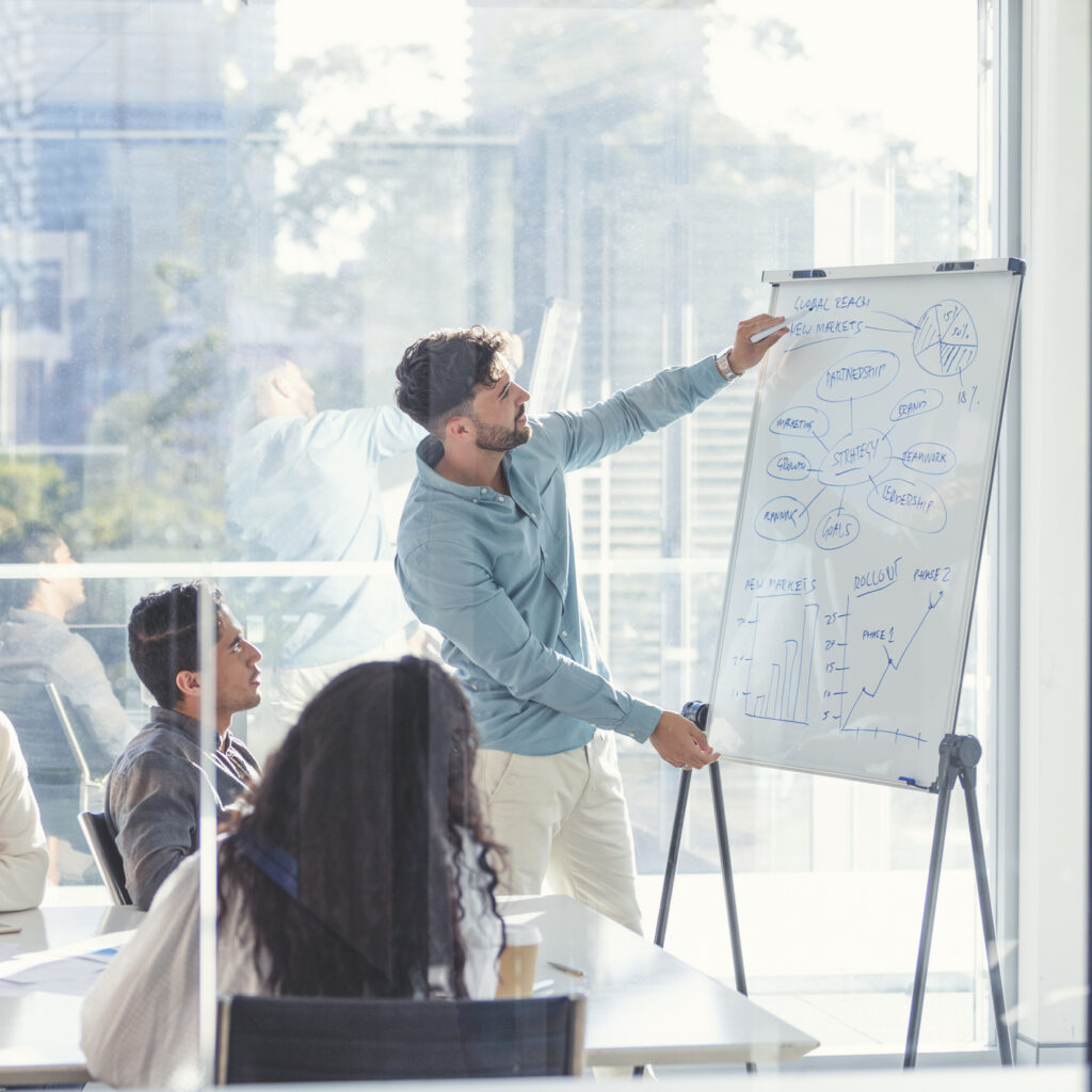Business People Watching A Presentation On The Whiteboard.