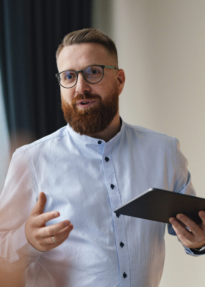 Confident Businessman Presenting Ideas At Office Meeting